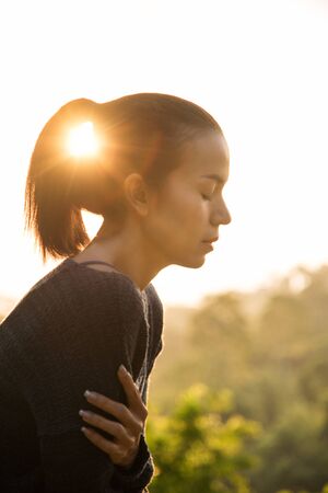 Portrait of a beautiful asia woman on the sunset nature summer evening background. people park and outdoor conceptの写真素材