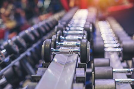 Black dumbbell set. Close up many metal dumbbells in sport fitness center , Weight Training Equipment sport concept.の写真素材