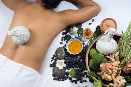 Herb spa background consists of compress, turmeric, galangal, ginger.の写真素材