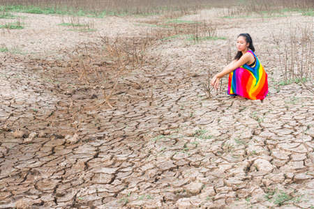 woman portrait in dryland with drought ground texture. concept climate changed.