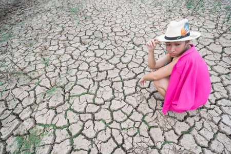 woman portrait in dryland with drought ground texture. concept climate changed.の写真素材
