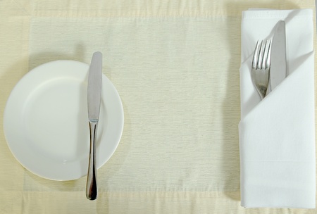 stainless fork knife and plate set on a table