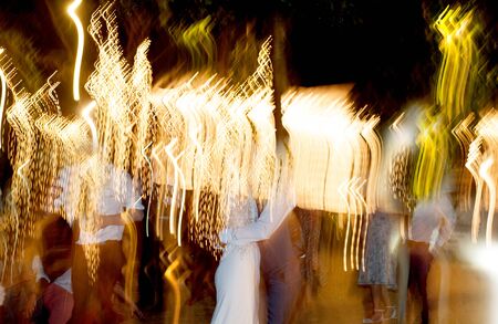 people dancing under lightの写真素材
