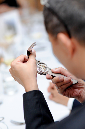 The watch is in the hands of a manの写真素材