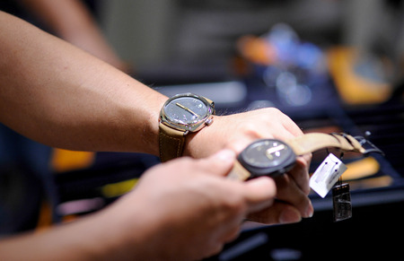 selecting a wrist watch from shop