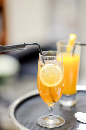 orange fruit juice on a tray at a partyの写真素材