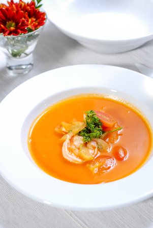 Close up of lobster soup on white plateの写真素材