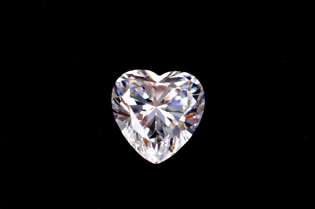 Photo of real large diamond with heart shape on black backgroundの写真素材