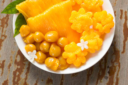 Thai dessert in white plate. Favorite dessert for propitious ceremony. Local name FoiThong ThongYip and MedKanoon. Top view.の写真素材