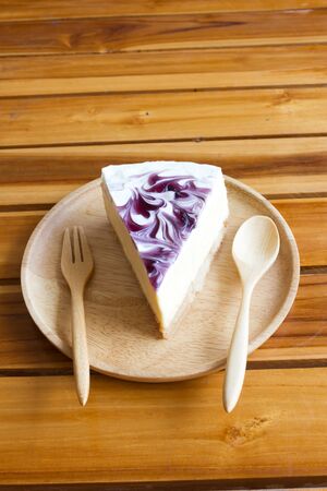 Blueberry cheesecake on wooden plate.の写真素材