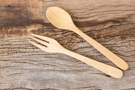 Kitchen tools on wooden background. Wooden fork and spoon. Top view.