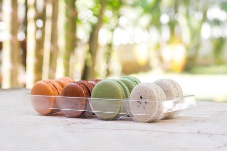 Closeup  colorful homemade macaroon in plastic package. With nature bokeh background.の写真素材