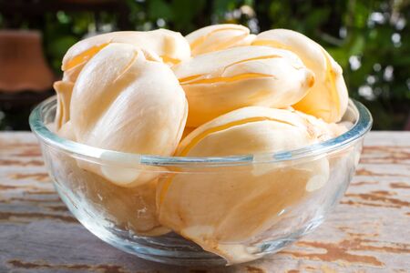 Toddy palm in glass bowl on wooden table. Fresh fruit. Asian fruit.の写真素材