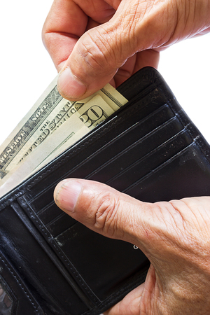 Old man's hand pick a dollar bill from old black leather wallet on white background.