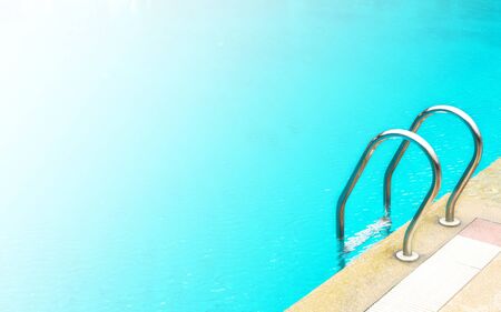 Stainless ladder of swimming pool. Outdoor background. Copy space background. With color filter