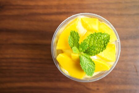 Mango smoothies in plastic cup. Refreshment healthy drink. Tropical fruit. Sweet tast but no sugar...