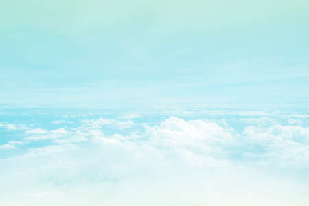 Cloudy sky from window airplane view. Nature and abstract background. Fluffy cloud like space on heaven. With color filter, pastel tone.の写真素材