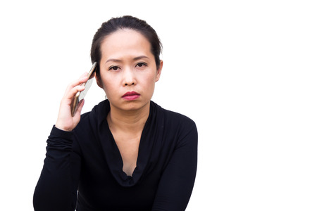 Concept of disappointed, business Asian woman used smart phone and fail something. Action of bored, do not  want to hear, take the phone away from ear. Portrait Asian woman on white isolate background.の写真素材
