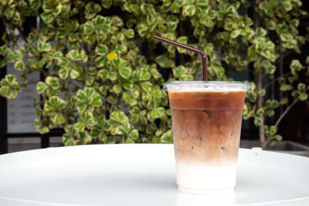 Glass of ice latte in plastic cup. Easy pagage of most useful. Favorite menu for caffeine lover with...