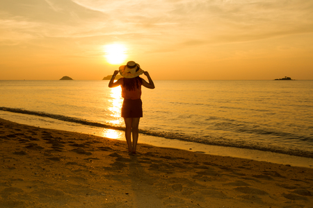 Girl joining sunset on the beach at Koh chang island, Thailandの写真素材