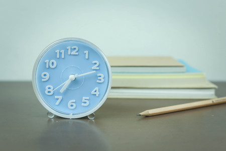 blue clock on work table