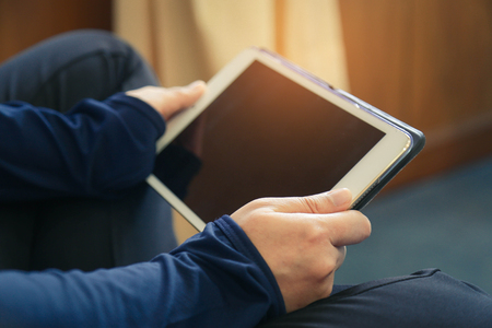 Woman's hands holding black tabletの写真素材