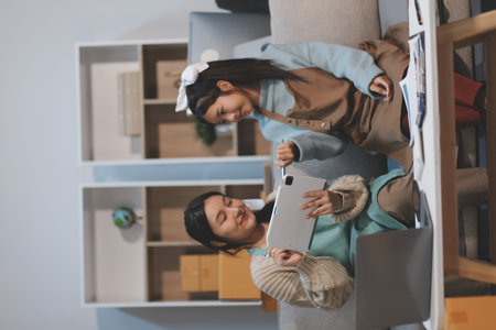 Young asian women happy after new order from customer. Surprise and shock face of asian woman success on making big sale of his online store. Online Selling. Online Shoppingの写真素材