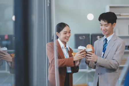 Young business people talking, working together in front of modern business buildingの写真素材