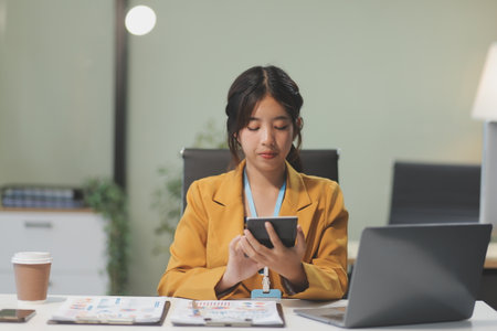 Young attractive businesswoman working on her project with laptop computer in modern office room.の写真素材