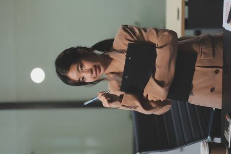 Asian women are stressed while working on laptop, Tired asian businesswoman with headache at office, feeling sick at work, copy spaceの写真素材
