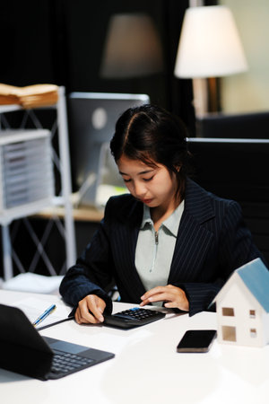 Real estate agents explain models of housing estates in projects to elaborate to clients, explaining and presenting information about homes and purchasing loans. Real estate trading concept.の写真素材