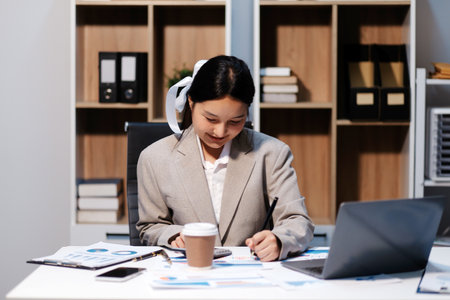 Asian businesswoman working happily about the success of the company,doing planning analyzing the financial report, business plan investment, finance analysis concept.の写真素材