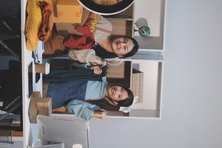 Young asian women happy after new order from customer. Surprise and shock face of asian woman success on making big sale of his online store. Online Selling. Online Shoppingの写真素材