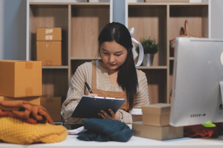 Young asian women happy after new order from customer. Surprise and shock face of asian woman...