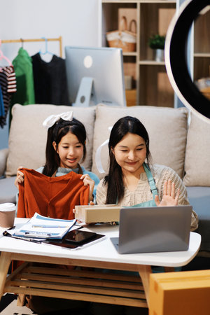 Young asian women happy after new order from customer. Surprise and shock face of asian woman success on making big sale of his online store. Online Selling. Online Shoppingの写真素材