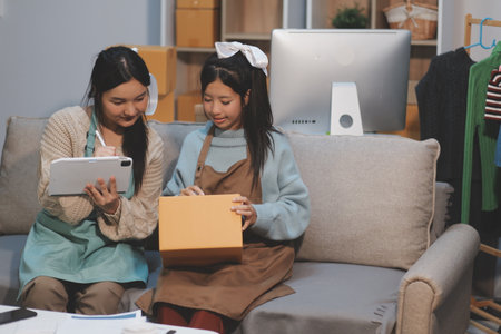 Young asian women happy after new order from customer. Surprise and shock face of asian woman success on making big sale of his online store. Online Selling. Online Shoppingの写真素材