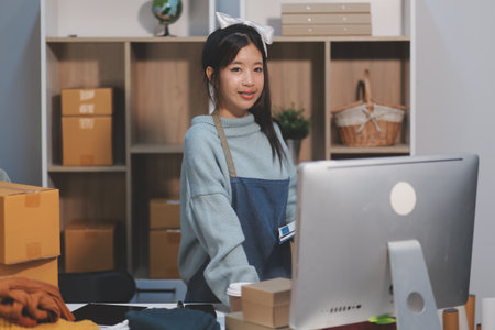 Young asian women happy after new order from customer. Surprise and shock face of asian woman...