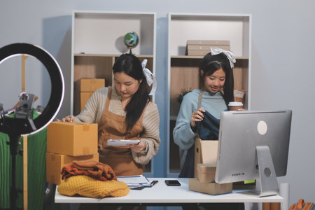Young asian women happy after new order from customer. Surprise and shock face of asian woman success on making big sale of her online store.の写真素材