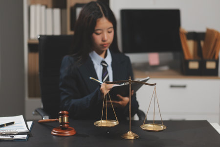 Law theme, mallet of the judge, law enforcement officers, evidence-based cases and documents taken into account.の写真素材