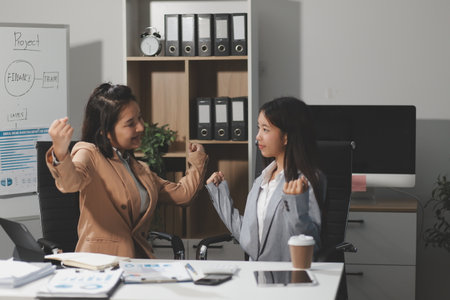 Entrepreneurs and business people in modern meeting room, happy multiracial coworkers have fun cooperating working together at office meeting, asian teamwork conceptの写真素材