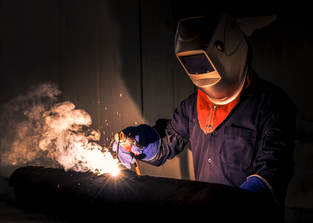 Industrial Worker at the factory welding closeupの写真素材