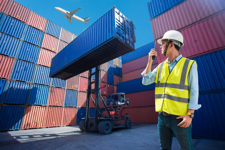 Foreman control loading containers box from cargo freight ship for import export, Foreman control industrial container cargo freight ship, Business logistic concept, Import and export conceptの写真素材