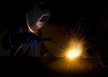 Industrial Worker at the factory welding closeup