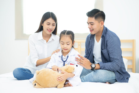 Little doctor, Cute little asian girl dressed like a doctor at homeの写真素材