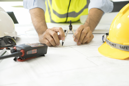 Architect working on blueprint,Engineer inspective in workplaceの写真素材