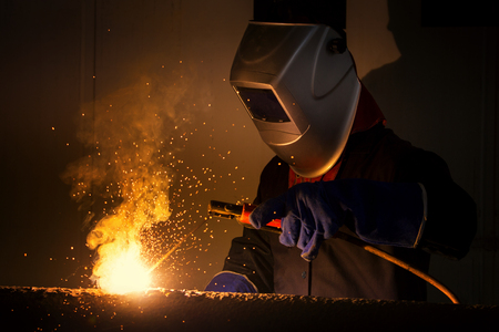 Industrial Worker at the factory welding closeupの写真素材