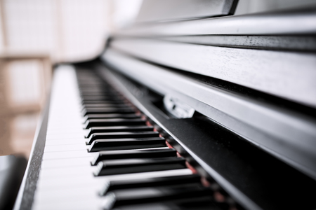 Piano keyboard background with selective focus. Warm color toned imageの写真素材