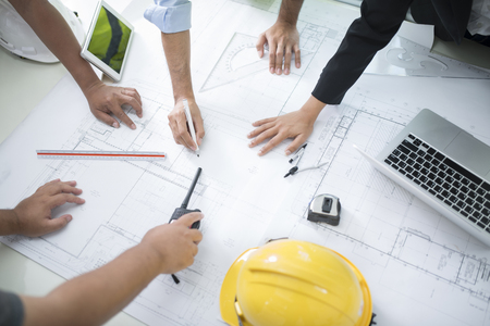 Image of engineer meeting for architectural project. working with partner and engineering tools on workplace vintage tone.の写真素材