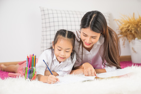 Young family drawing together with colorful pencils at homeの写真素材