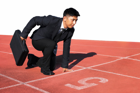 A businessman on a track ready for race in businessの写真素材